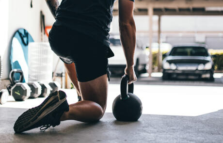 Industry news man outside kettlebell Stock Unsplash column